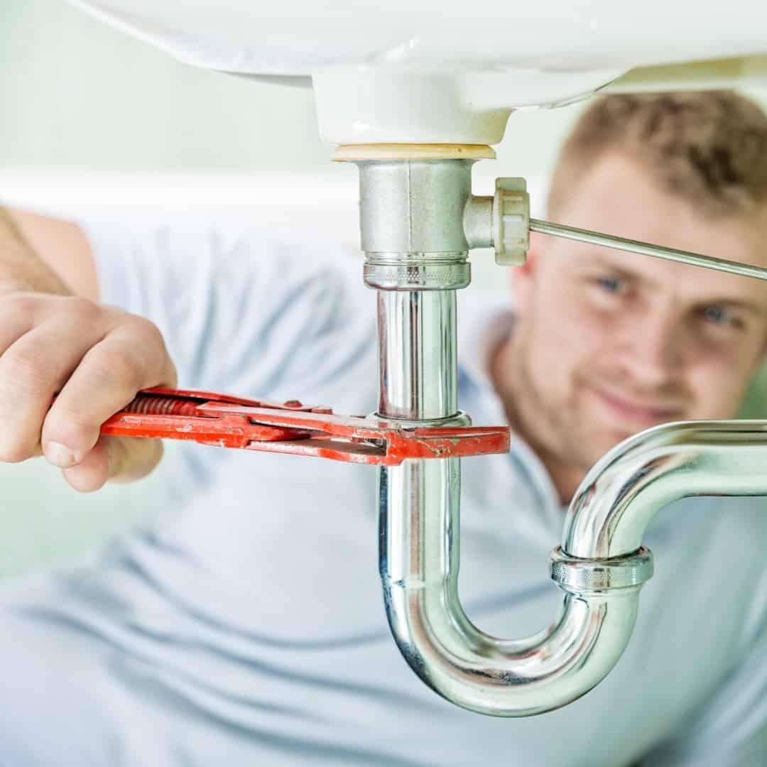 Plumber Cleaning Pipe